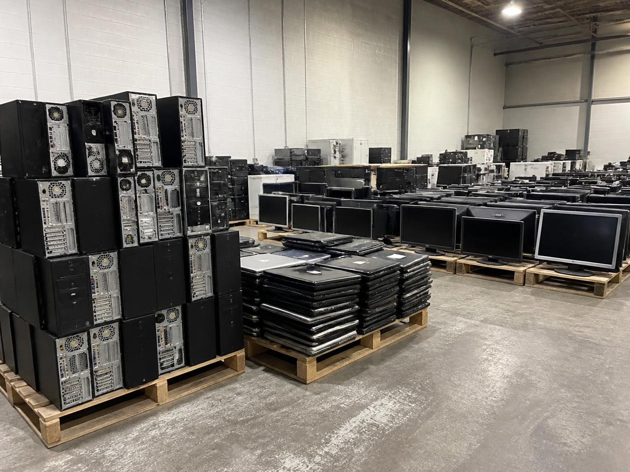 Sorted bins of circuit boards, copper and plastics in an electronics recycling facility